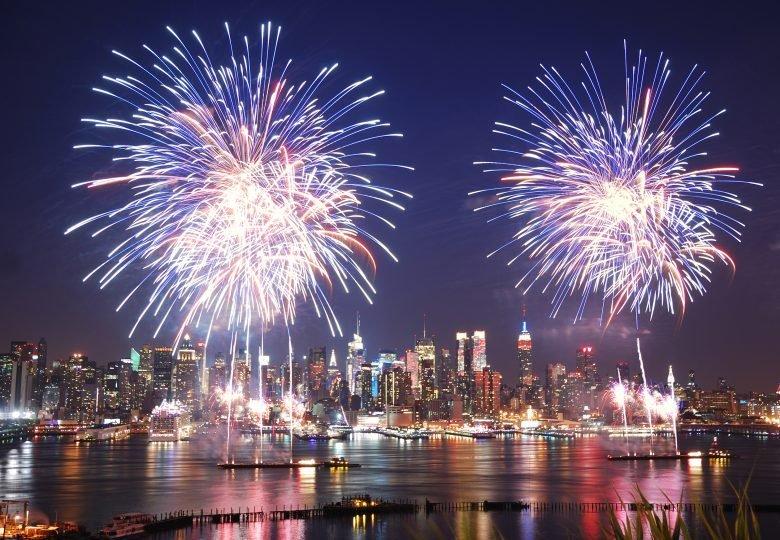 fireworks in the night sky over a body of water