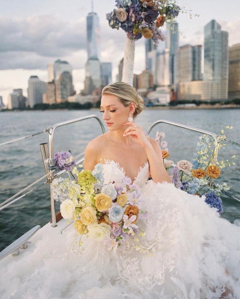 woman posing with flowers after a boat marriage proposal in New York City