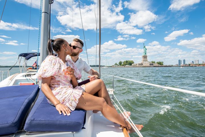 couple kissing during a marriage proposal on a yacht