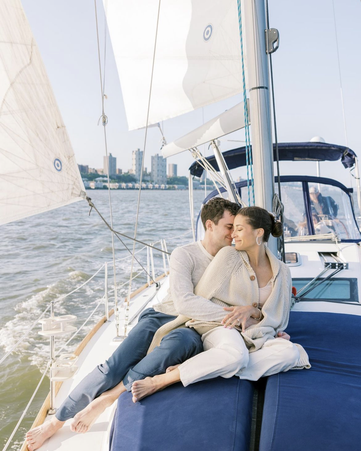 couple sitting on a sailboat in NYC for a romantic boat ride