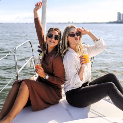 two women sitting on the bow of a boat during a NYC brunch cruise