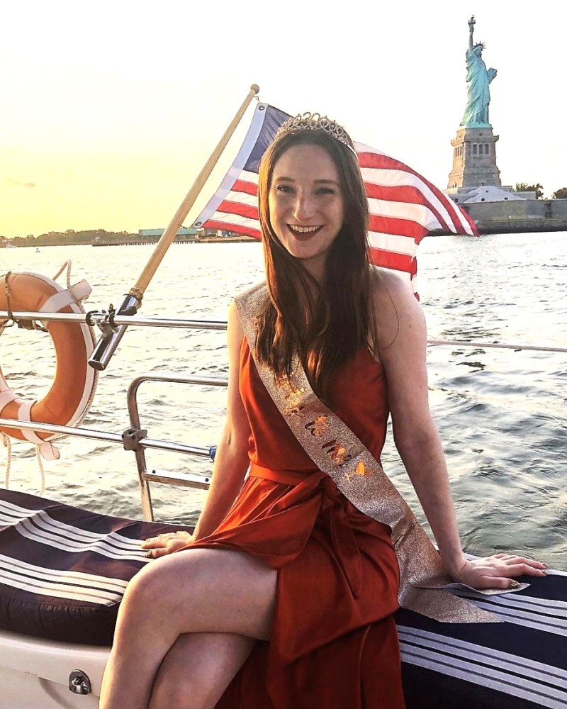 a woman sitting on a boat in a body of water